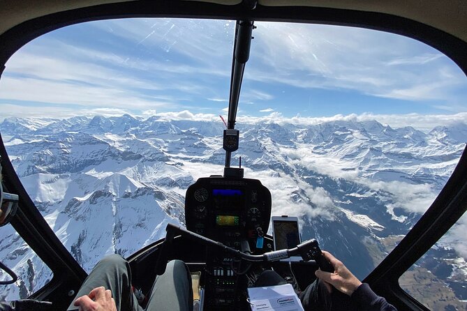 Private Swiss Alps helicopter tour over snow covered mountain peaks and glaciers - Lake Thun and its glacier-fed color