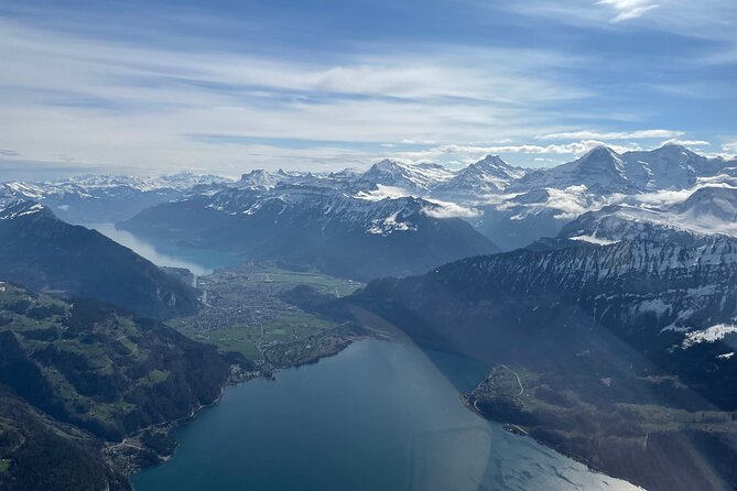 Private Swiss Alps helicopter tour over snow covered mountain peaks and glaciers - Lake Brienz and the steep walls around it